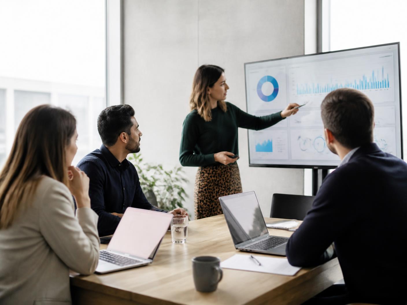 Team reviewing store performance dashboards in a meeting room